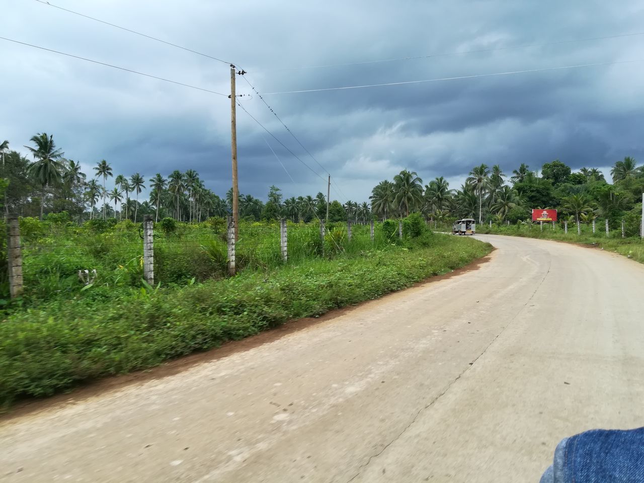 ROAD ON FIELD AGAINST SKY