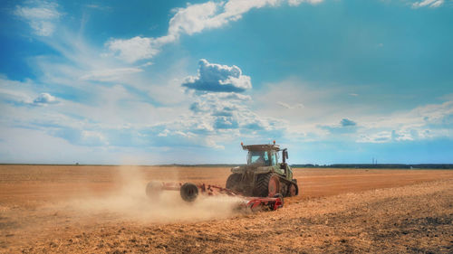 Scenic view of agricultural field against sky