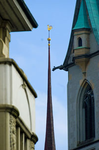 Low angle view of weather vane by church