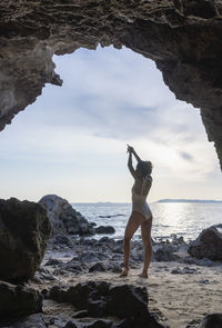 Slim woman raising hands for yoga or posing to open the mind to beautiful things. 