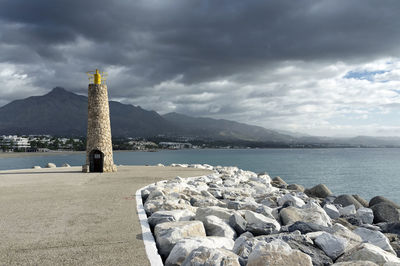 Rocks by sea against sky