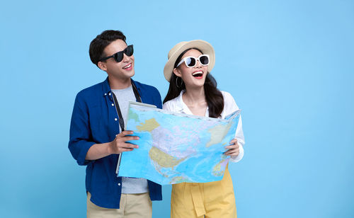 Young couple holding blue camera