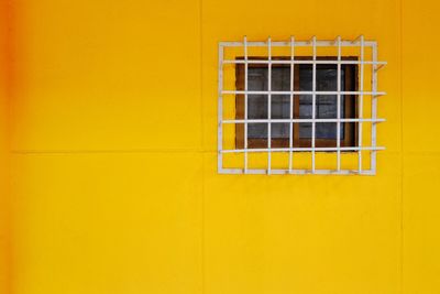 Close-up of yellow window on wall