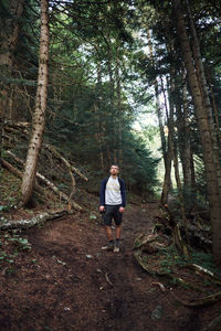 Full length of man walking in forest