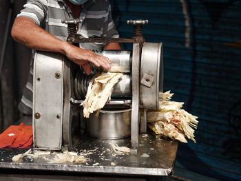 Midsection of man working on table