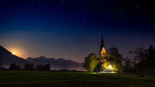 Panoramic view of illuminated church against sky at night