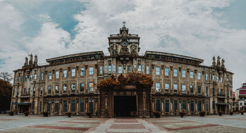 View of old building against cloudy sky