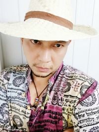 Close-up portrait of young man wearing hat
