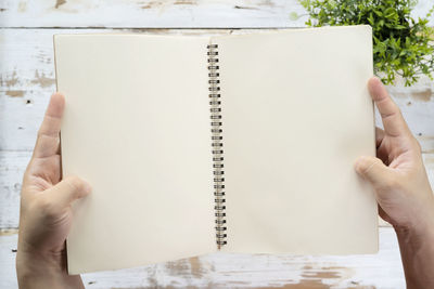 Close-up of hand holding book