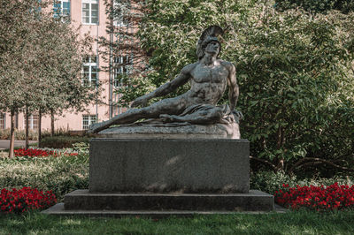 Statue against plants in park