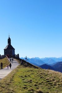 People walking towards church at bavarian alps