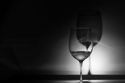 Close-up of wineglass against black background