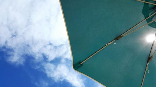 Low angle view of skyscraper against cloudy sky