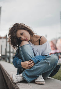 Portrait of smiling woman sitting outdoors