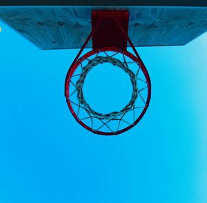 Low angle view of basketball hoop against blue sky