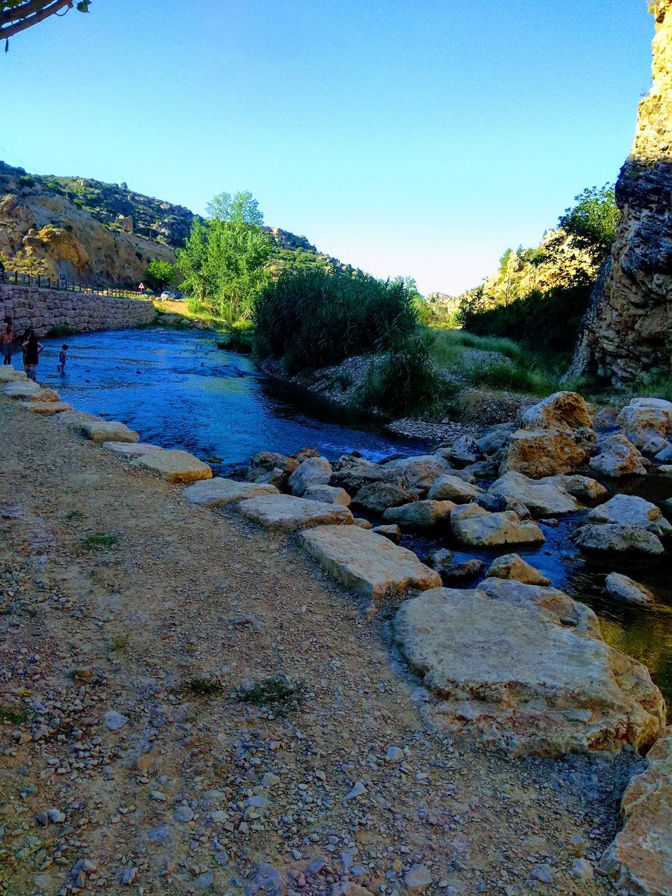 sky, water, rock, tranquility, clear sky, nature, tranquil scene, no people, solid, beauty in nature, rock - object, river, day, tree, plant, scenics - nature, land, non-urban scene, outdoors, flowing, flowing water