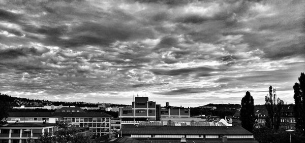 Buildings against cloudy sky