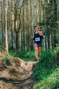 Full length of woman running in forest