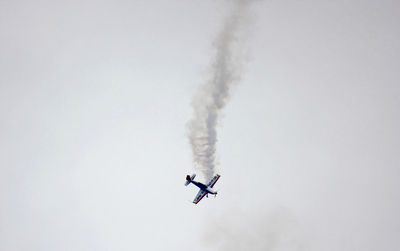 Low angle view of airplane flying against clear sky