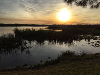 Scenic view of lake against sky during sunset