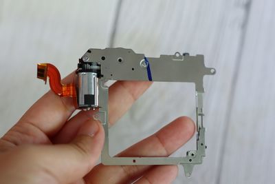 Cropped hand of man repairing machine