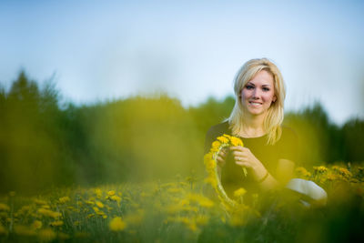 Portrait of woman with flowers in background