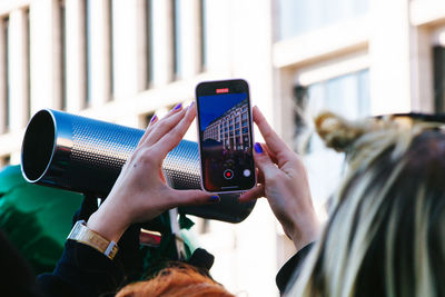 Midsection of woman using mobile phone