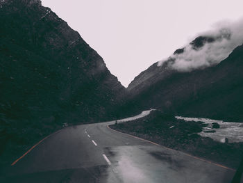 Road amidst mountains against sky