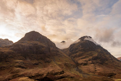 Scenic view of mountains against cloudy sky