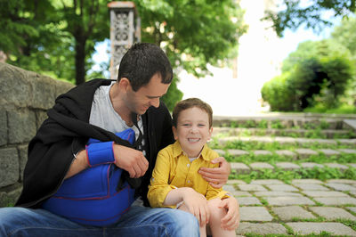 Rear view of friends sitting outdoors