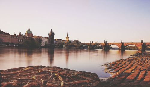 Bridge over river with city in background