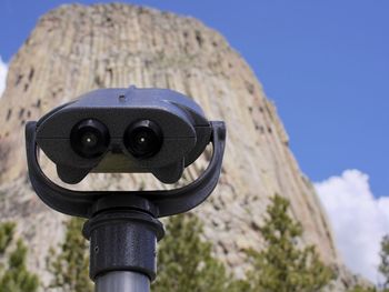 Close-up of coin-operated binoculars against sky