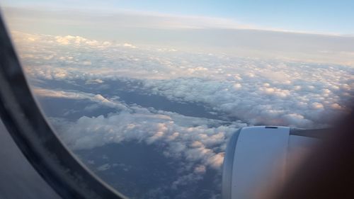 Aerial view of clouds seen through airplane window