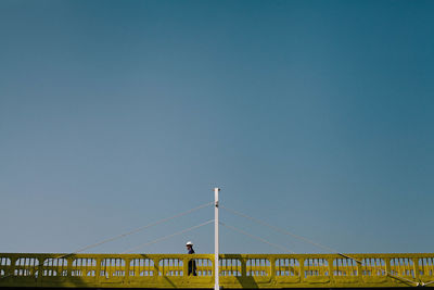 Road sign against blue sky