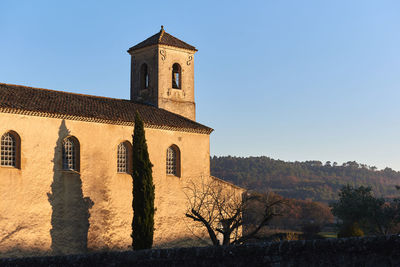 Low angle view of bell tower against sky