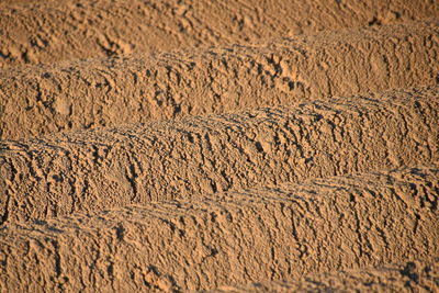 Full frame shot of tire tracks on sand