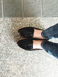 Low section of woman standing on tiled floor