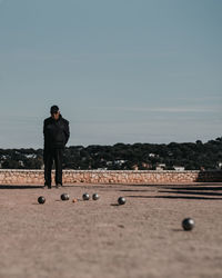 Rear view of man standing against sky