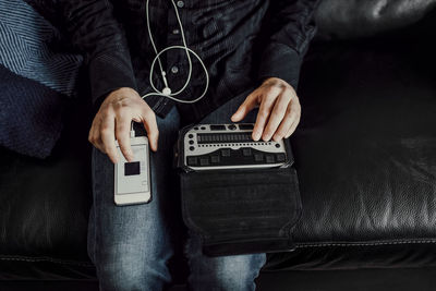 Man using braille keyboard and smart phone