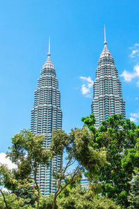 Kuala lumpur, malaysia - february 21, 2020. petronas twin towers against blue sky.