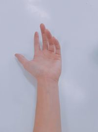 Close-up of hand over white background