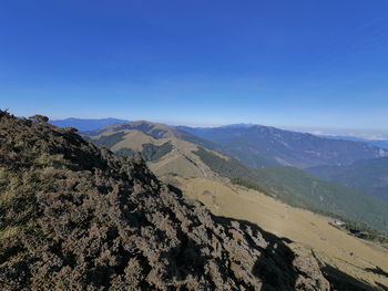 Scenic view of mountains against clear blue sky