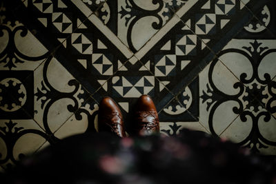 Low section of person standing on tiled floor