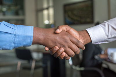 Cropped image of business people shaking hands at office