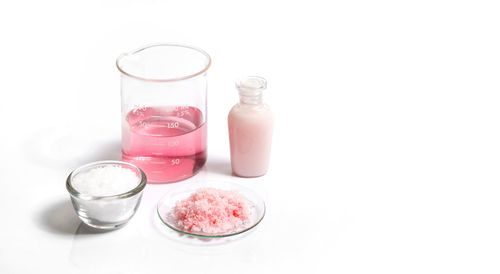 Close-up of glass of jar against white background