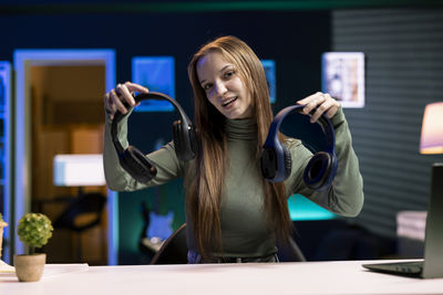 Portrait of young woman using mobile phone in gym