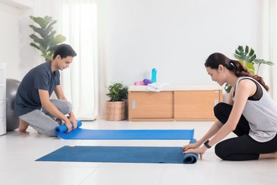 Side view of young couple sitting at home