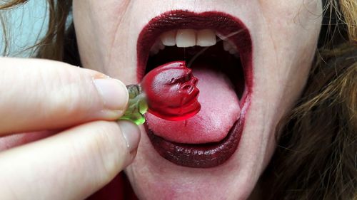 Close-up of woman eating candy