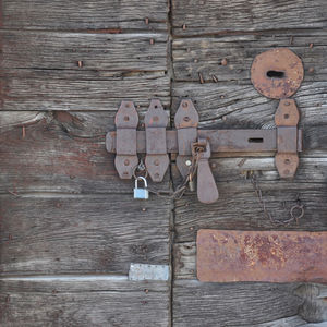 Rusty padlocks on wooden door