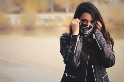 Portrait of woman wearing skull print scarf